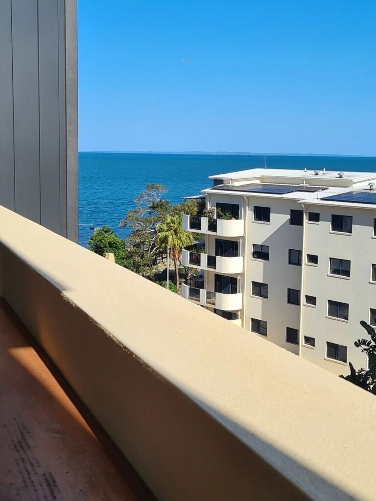 a picture of a beach from a apartment balcony