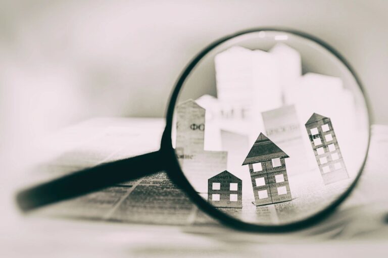 paper houses under a magnifying glass