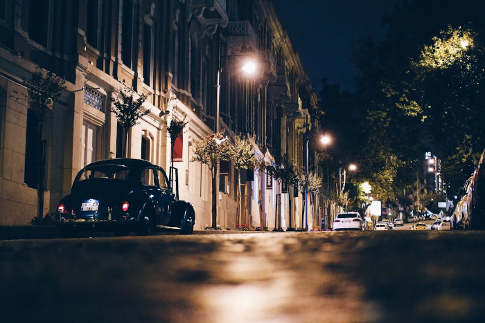 a street at night lit up dimly by streetlights