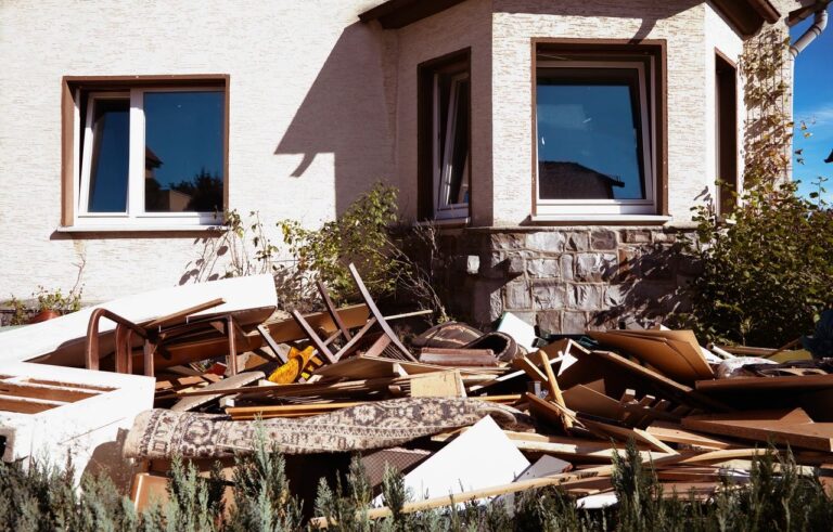 a house surrounded by trashed furniture