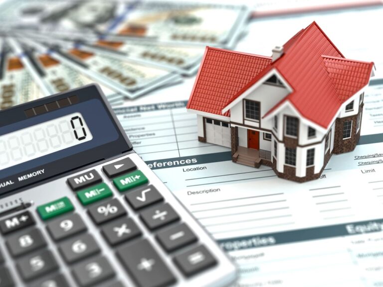 a calculator next to a small model house