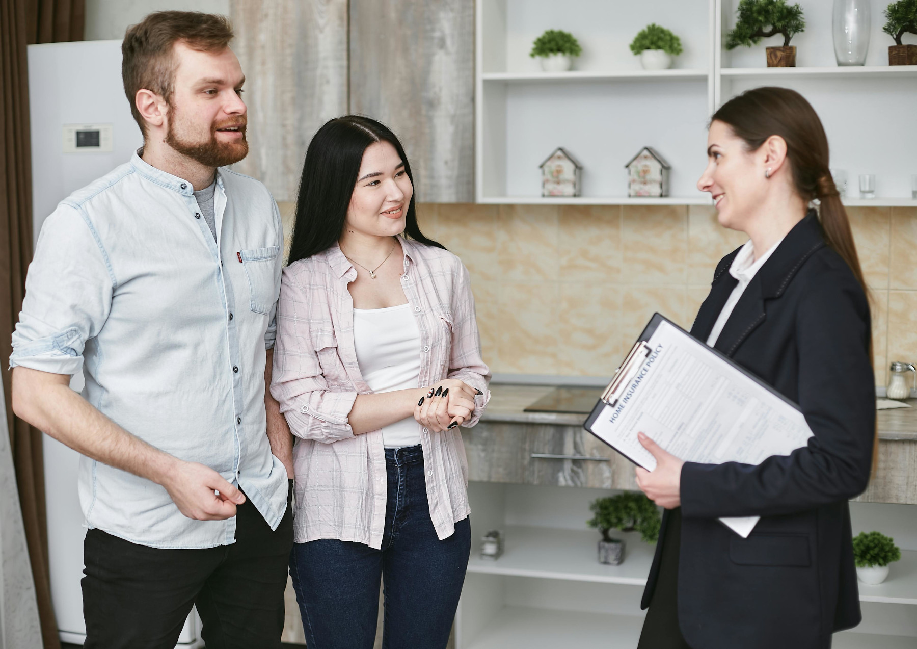 Smiling couple talking with a buyers agent