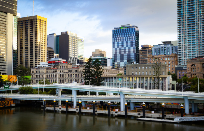Vibrant Brisbane cityscape showcasing skyscrapers and iconic river bridge.