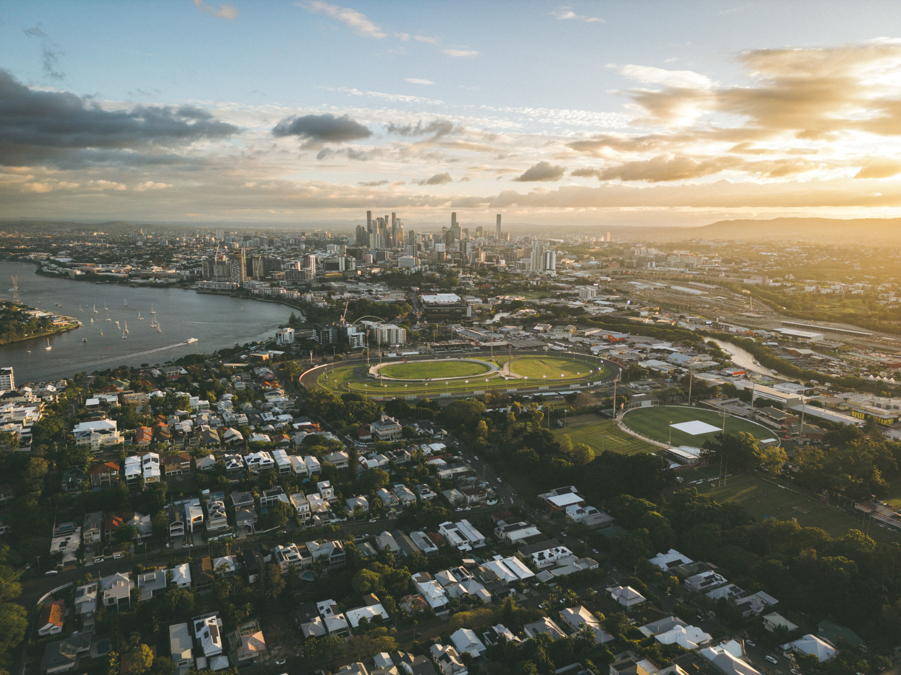 aerial view of Brisbane, Queensland at sunset with city skyline and river.